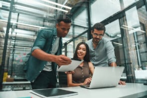 Group Of Employees Working On Laptop To Find Ransomware Prevention Tools